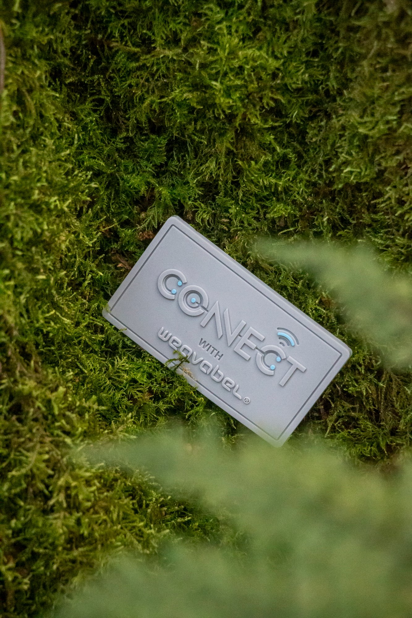 Weavabel Connect recycled silicone badge on moss