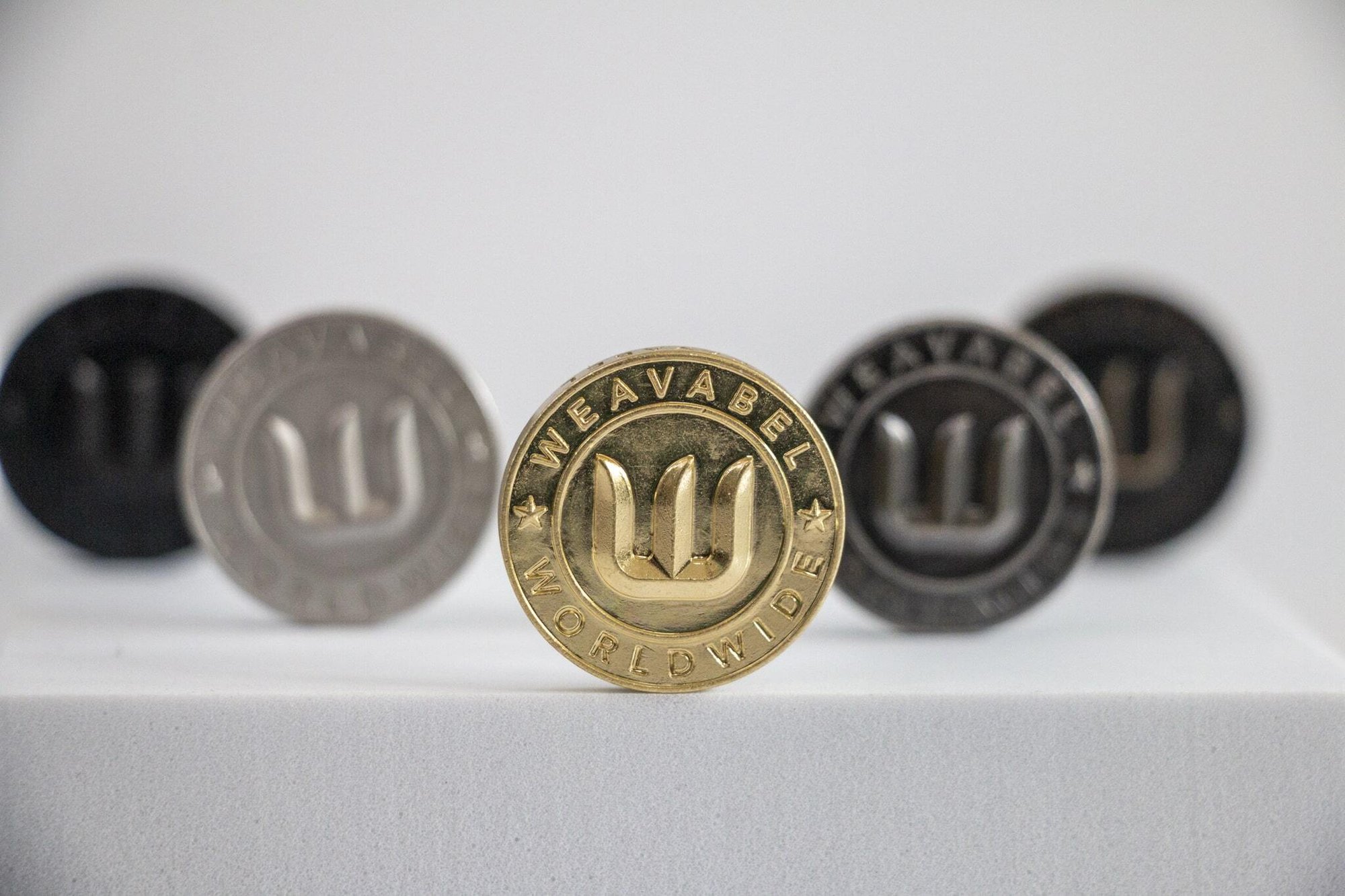 Weavabel brass moulded button.