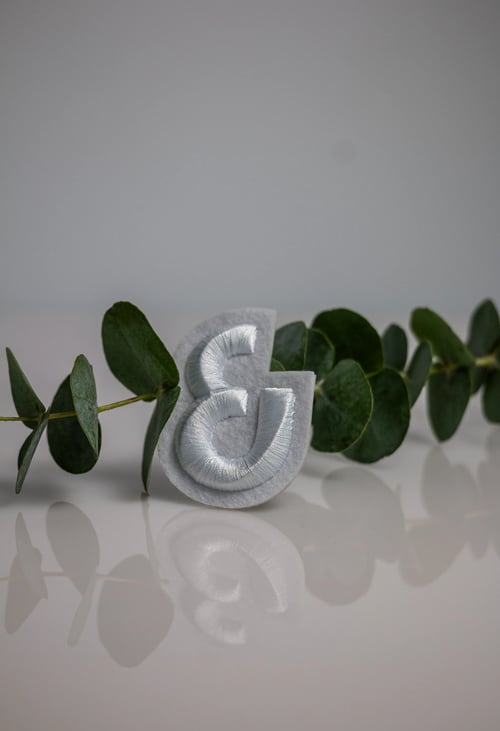 AND Collection embroidered badge