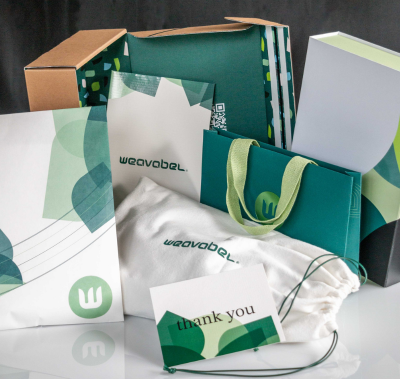 Custom branded packaging set including polybags, tissue paper and boxes for apparel products.