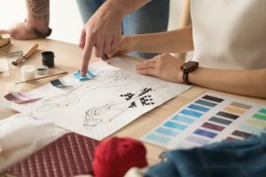 Two designers choosing fabric swatches.