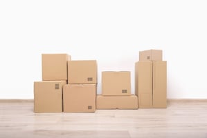 Several cardboard boxes against a white wall