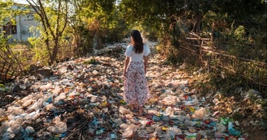 Person walking down a both covered in plastics and rubbish