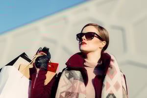 Fashion model carrying her shopping purchases