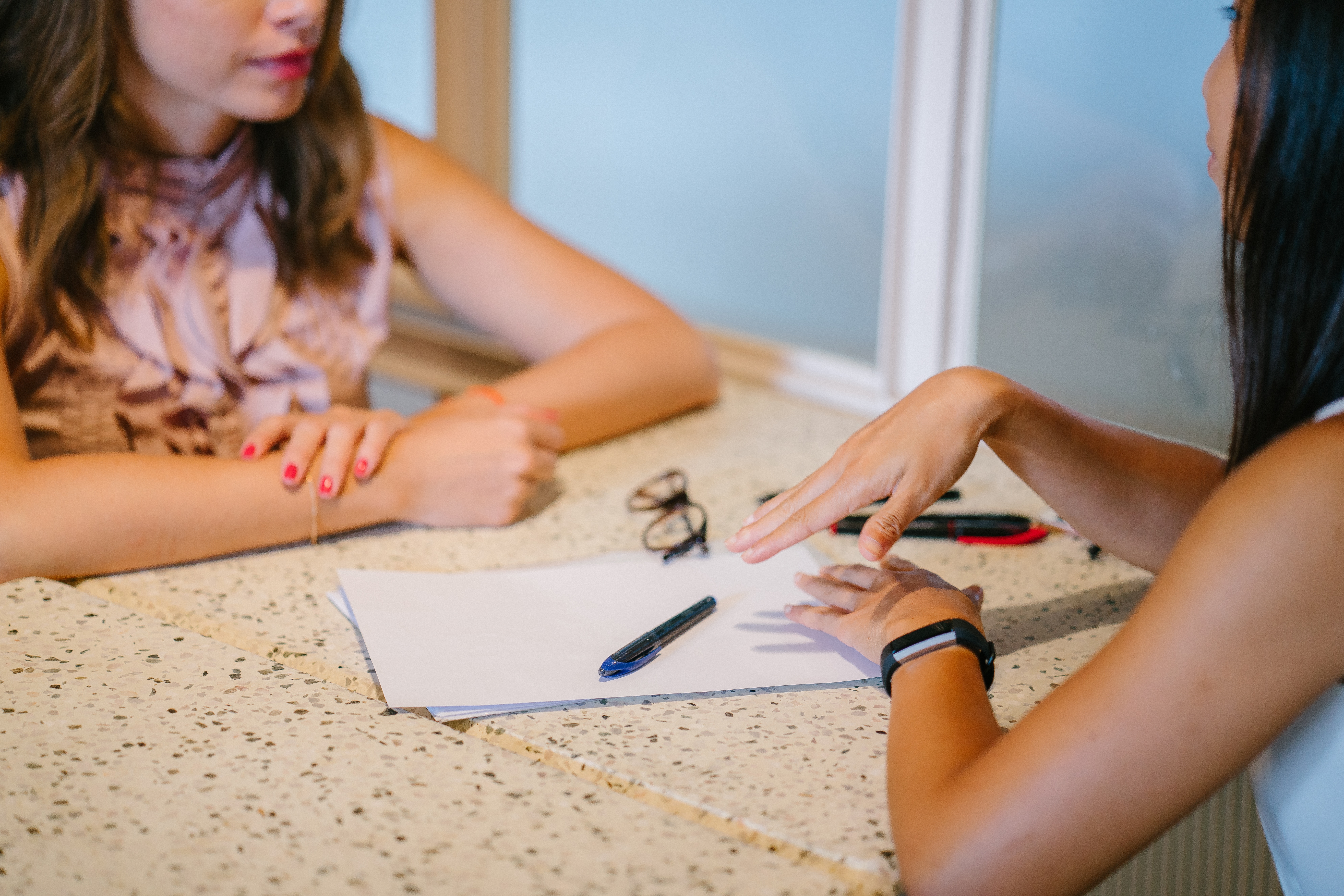 Two people sat at a table having a discussion