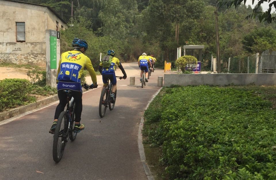 Oliver Wei cycling along a path