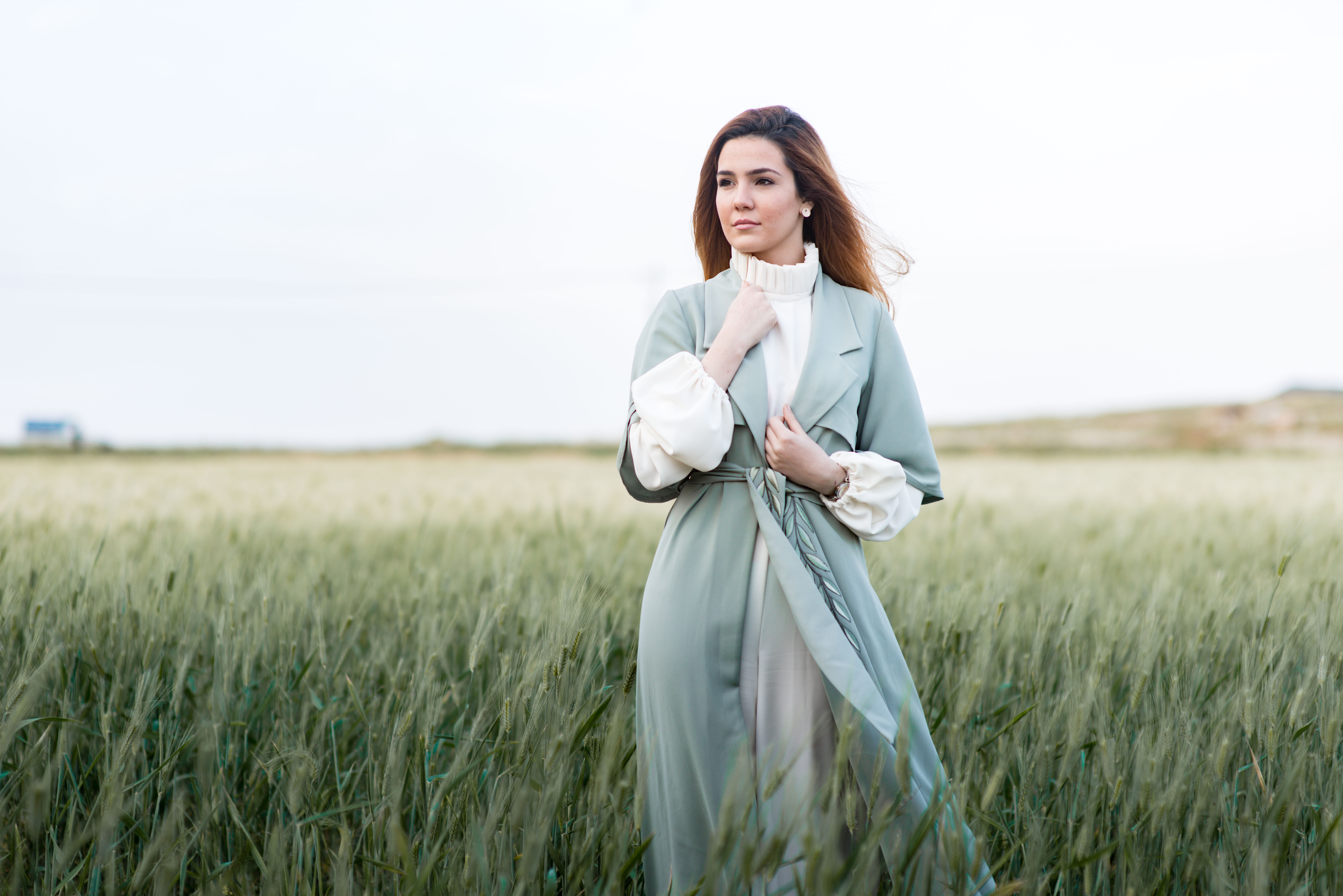 Female model, standing in a field of grass